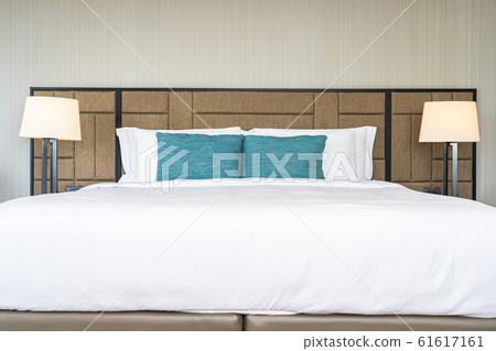 White comfortable pillow on bed decoration interior White comfortable pillow on bed decoration interior 61617161