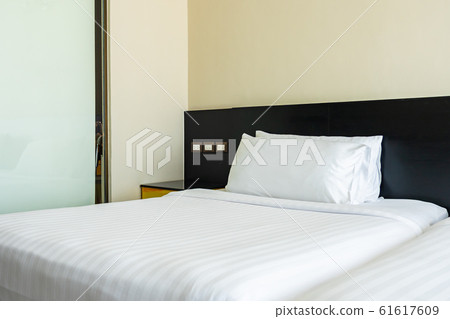 Pillow and blanket on bed with light lamp decoration interior 61617609