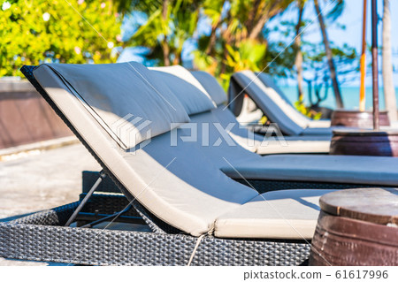 Umbrella and chair around swimming pool in hotel resort neary sea ocean beach for vacation 61617996
