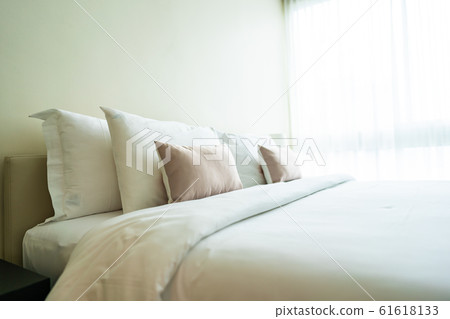 White comfortable pillow on bed decoration interior White comfortable pillow on bed decoration interior 61618133