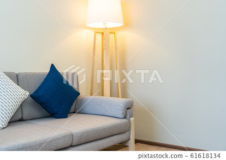 Comfortable pillow on sofa decoration with light lamp interior Comfortable pillow on sofa decoration with light lamp interior 61618134