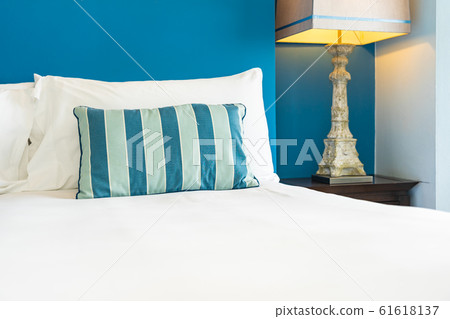 White comfortable pillow on bed decoration interior White comfortable pillow on bed decoration interior 61618137
