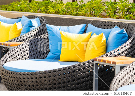 Outdoor patio in the garden with sofa chair and pillow decoration 61618467