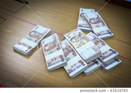 one million baht of thai money currency put on table business office financial one million baht of thai money currency put on table business office financial 61619783