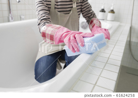 Young woman cleaning bath Young woman cleaning bath 61624258