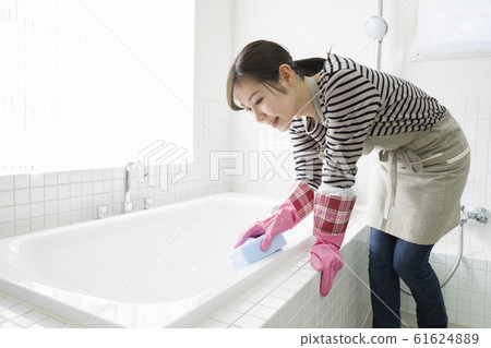 Bath cleaning young woman housewife housework 61624889