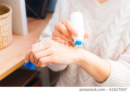 Woman applying insect bite medicine Woman applying insect bite medicine 61627807