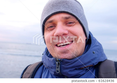 Selfie video of man blogger talking with subscrubers or video chat at sea. 61628436