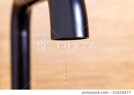 Small drop from tap. saving water concept. Small drop from tap. saving water concept. 61629477