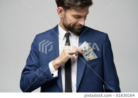 young handsome businessman holding US dollar bill 61630164