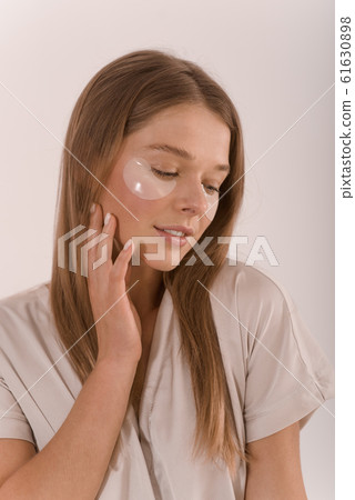 Portrait of a young woman with with a eyepatch on her face. Portrait of a young woman with with a eyepatch on her face. 61630898