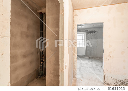 Empty interior for design, gray concrete wall. Empty room. Space for text and picture. Concrete walls, slabs, interior of a new residential building. Partitions in a new apartment. Empty interior for design, gray concrete wall. Empty room. Space for text and picture. Concrete walls, slabs, interior of a new residential building. Partitions in a new apartment. 61631013