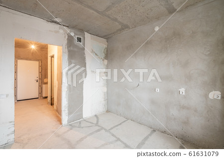 Empty interior for design, gray concrete wall. Empty room. Space for text and picture. Concrete walls, slabs, interior of a new residential building. Partitions in a new apartment. Empty interior for design, gray concrete wall. Empty room. Space for text and picture. Concrete walls, slabs, interior of a new residential building. Partitions in a new apartment. 61631079
