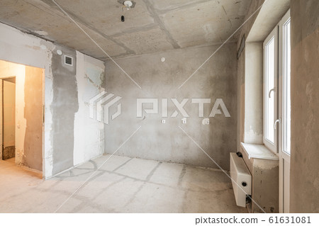 Kitchen. Empty interior for design, gray concrete wall. Empty room. Space for text and picture. Concrete walls, slabs, interior of a new residential building. Partitions in a new apartment 61631081