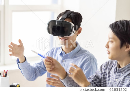 Lifestyle of two men who experience the latest technology of 5G in 3D with VR goggles 61631202