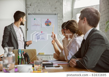 Group of young business professionals having a meeting, creative office Group of young business professionals having a meeting, creative office 61631695