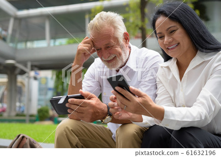 Mature multi-ethnic couple happy and in love while exploring the Mature multi-ethnic couple happy and in love while exploring the 61632196