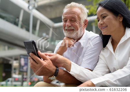 Mature multi-ethnic couple happy and in love while exploring the Mature multi-ethnic couple happy and in love while exploring the 61632206
