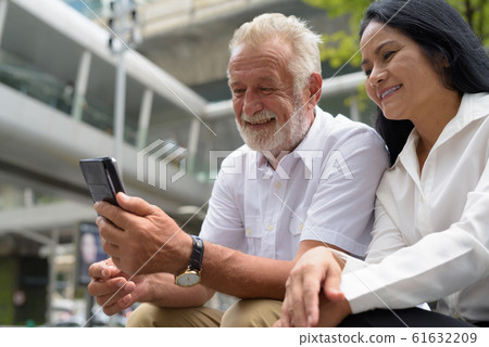 Mature multi-ethnic couple happy and in love while exploring the Mature multi-ethnic couple happy and in love while exploring the 61632209