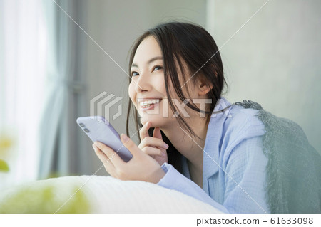Woman pajamas bed sleep waking up smartphone smartphone Woman pajamas bed sleep waking up smartphone smartphone 61633098