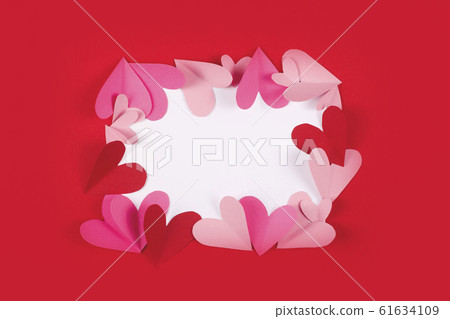 Frame for text from paper hearts on red. 61634109