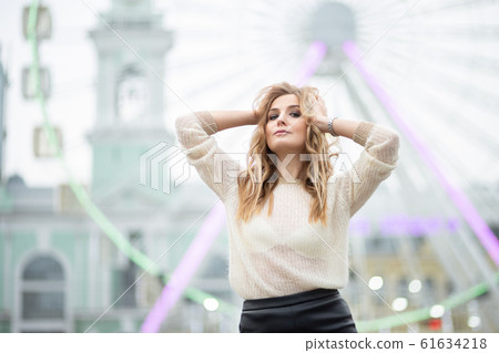 Gorgeus blonde woman in leather skirt posing on 61634218