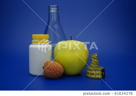 Still life with measuring tape and fruits Still life with measuring tape and fruits 61634276