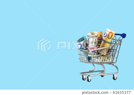 Shopping cart full of money isolated on blue 61635377