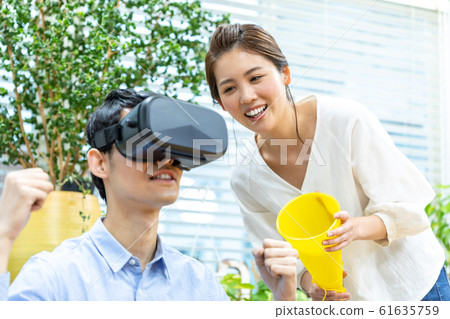 Couple watching sports in VR Couple watching sports in VR 61635759