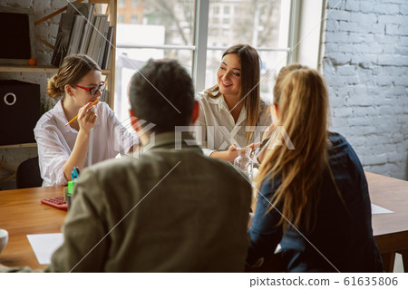 Group of young business professionals having a meeting, creative office Group of young business professionals having a meeting, creative office 61635806