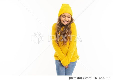 Happy caucasian girl in yellow hat and hoody basks isolated on white background Happy caucasian girl in yellow hat and hoody basks isolated on white background 61636082