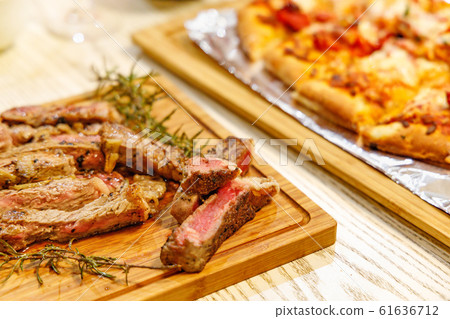 Sirloin steak and freshly baked pizza Sirloin steak and freshly baked pizza 61636712