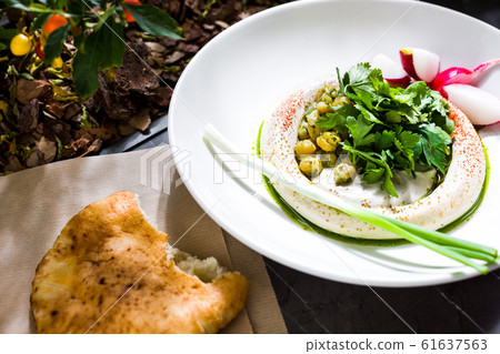 Hummus with chickpea grains. The cuisine of Tel 61637563