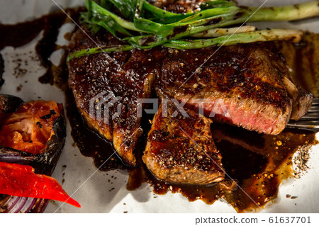 Beef steak with vegetables. The cuisine of Tel Beef steak with vegetables. The cuisine of Tel 61637701