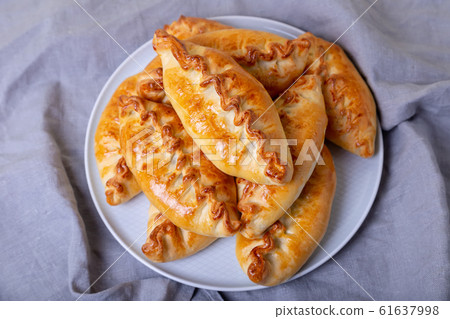 Pies (pirozhki) with cabbage. Homemade baking. Traditional Russian and Ukrainian cuisine. Close-up. 61637998
