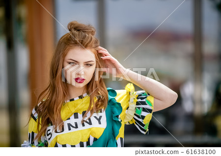 Bright photo of a woman during a vacation on a walk through the city's warm landscapes 61638100