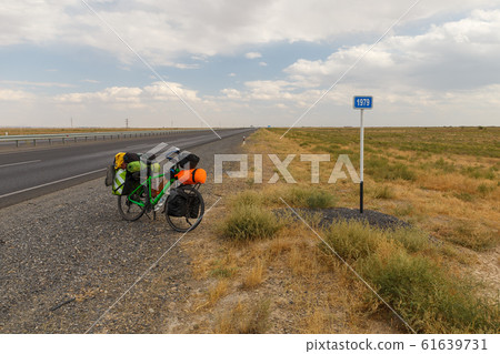 bicycle for a traveler stands on the road near a bicycle for a traveler stands on the road near a 61639731