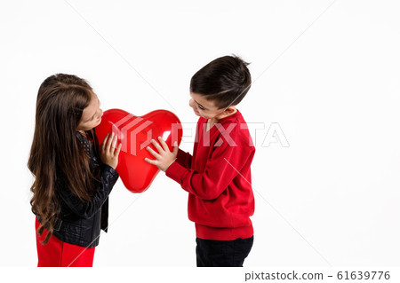 Happy kids with red heart balloon 61639776