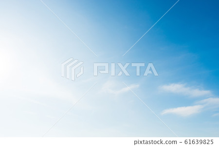 Bright and soft blue sky with small white clouds 61639825
