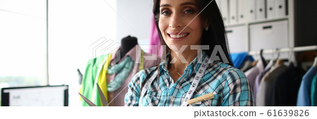 Joyful woman with scissors 61639826