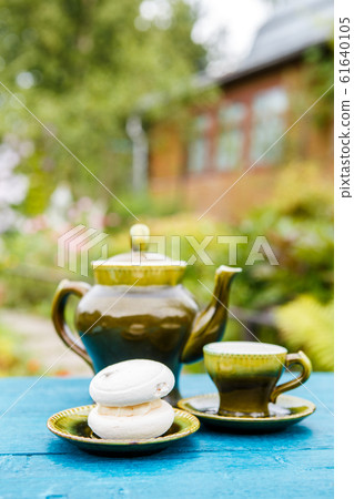 Teapot and cups with cake on table Teapot and cups with cake on table 61640105