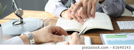 Male interpreter businessman hand pointing on diary Male interpreter businessman hand pointing on diary 61640143