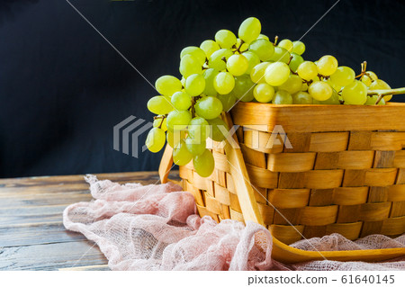 Photo of green grapes in wooden box, on cloth Photo of green grapes in wooden box, on cloth 61640145