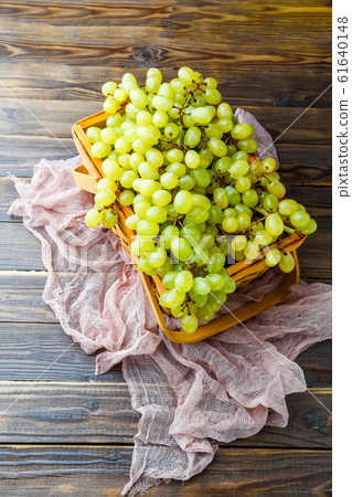 Image from above of green grapes in wooden box with pink cloth Image from above of green grapes in wooden box with pink cloth 61640148