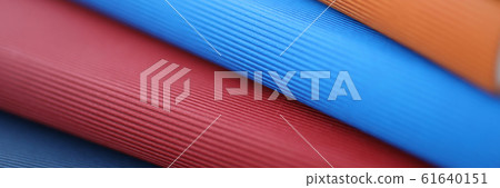 Stack of colorful books lies on a table closeup Stack of colorful books lies on a table closeup 61640151