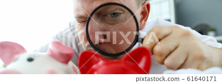 Male musinessman hold magnifying glass in hand 61640171