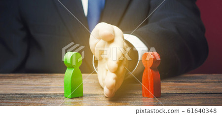 Man divides warring parties conflict with a hand. Mediator services. Stop fight, ceasefire clashes. Finding a compromise. De-escalation of conflict. Avoid the war, start the negotiation process 61640348