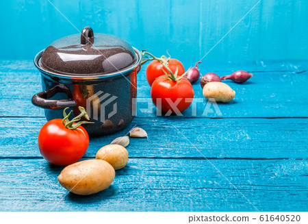 Photo of iron pot for soup, tomato, potatoes, onions 61640520