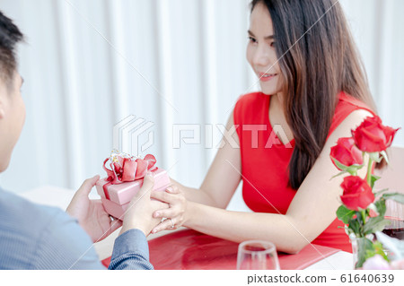 Girl receiving gift box, Valentive's day. 61640639