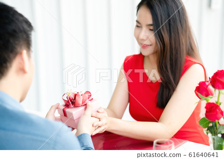 Girl receiving gift box, Valentive's day. Girl receiving gift box, Valentive's day. 61640641